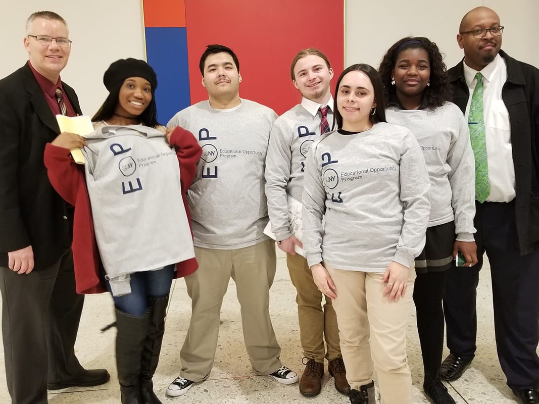 Students standing in group wearing EOP t-shirts.