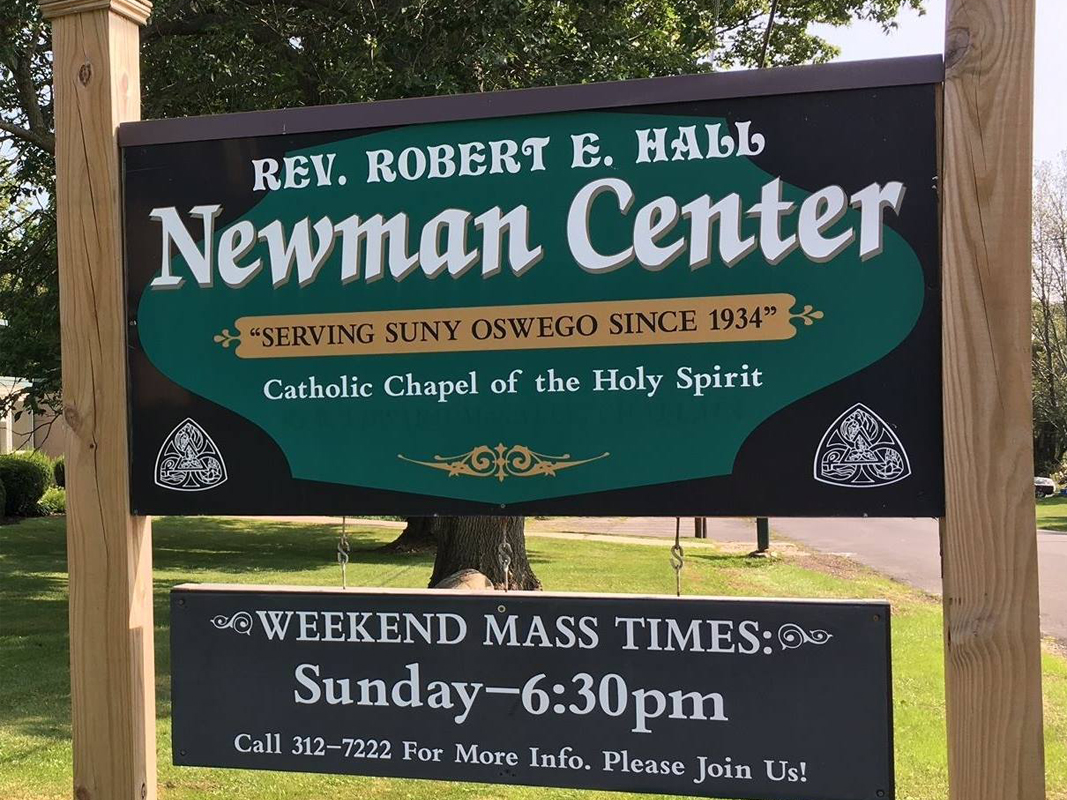 Newman Center in white lettering against green and black background